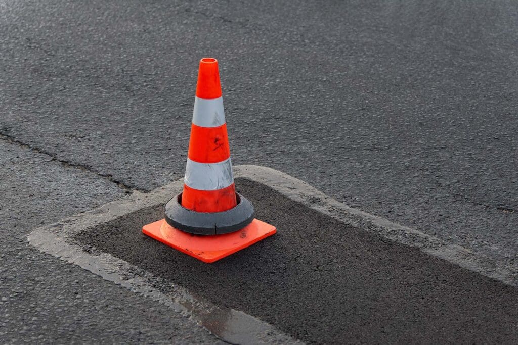 Caution Cone on wet asphalt