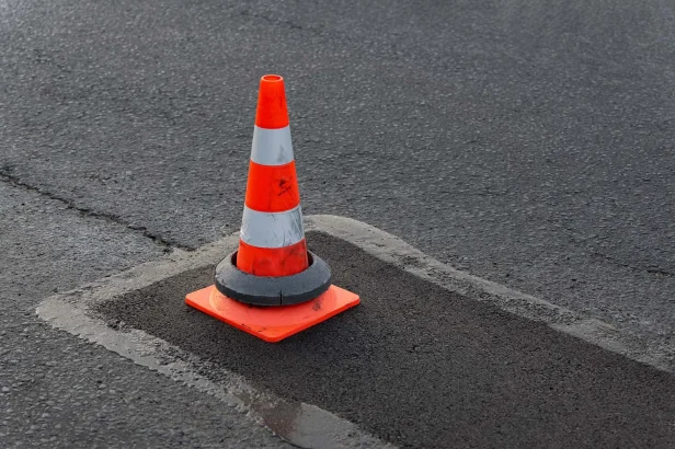 Caution Cone on wet asphalt